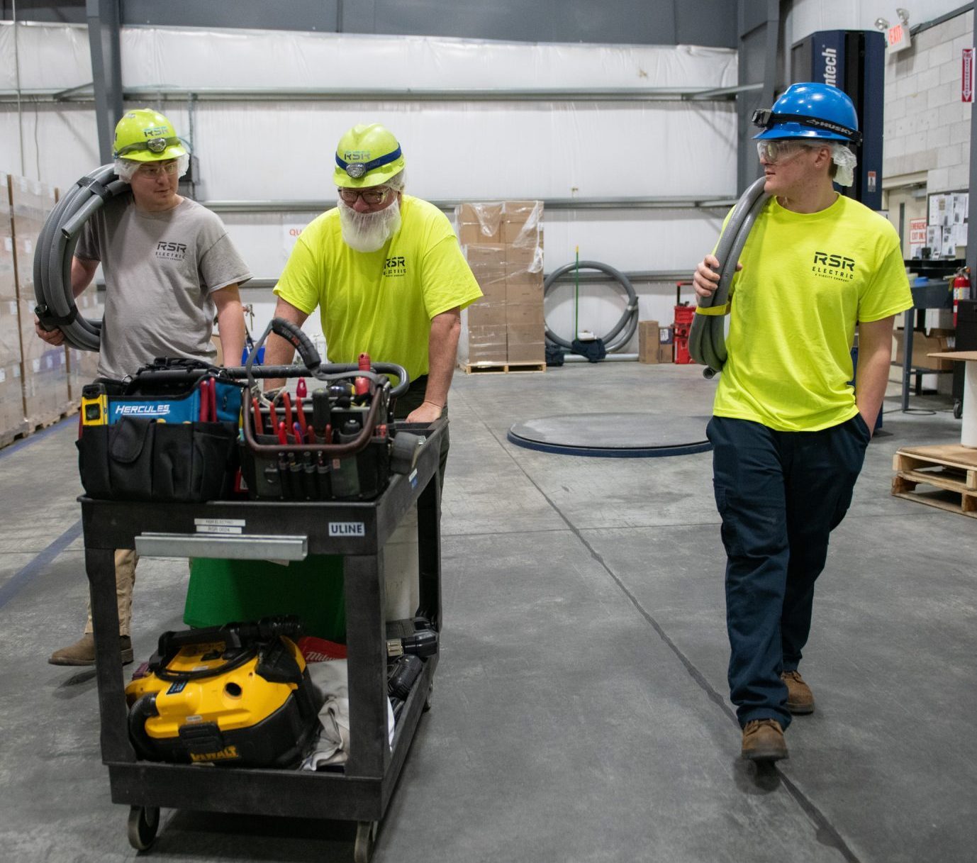rsr electricians walking through facility with tools